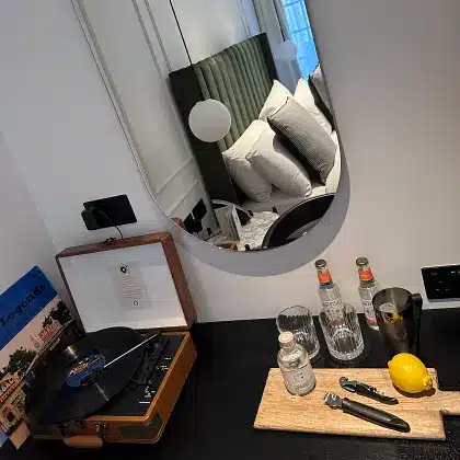Vinyl record player and gin station in the Balliol College Junior Suite room at The Store hotel in Oxford