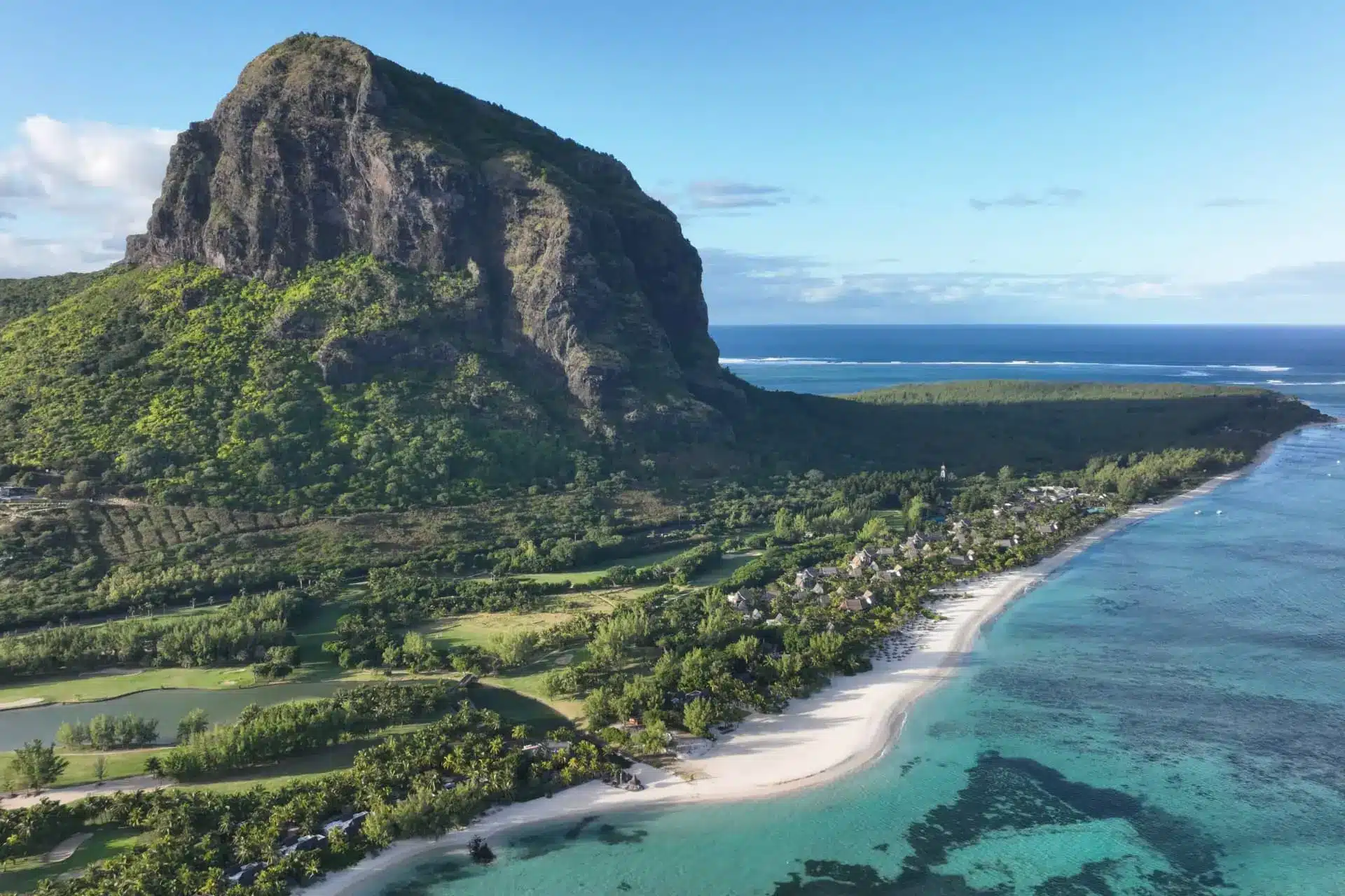 Aerial view of Le Morne mountain, white-sand beach, and turquoise lagoon in Mauritius