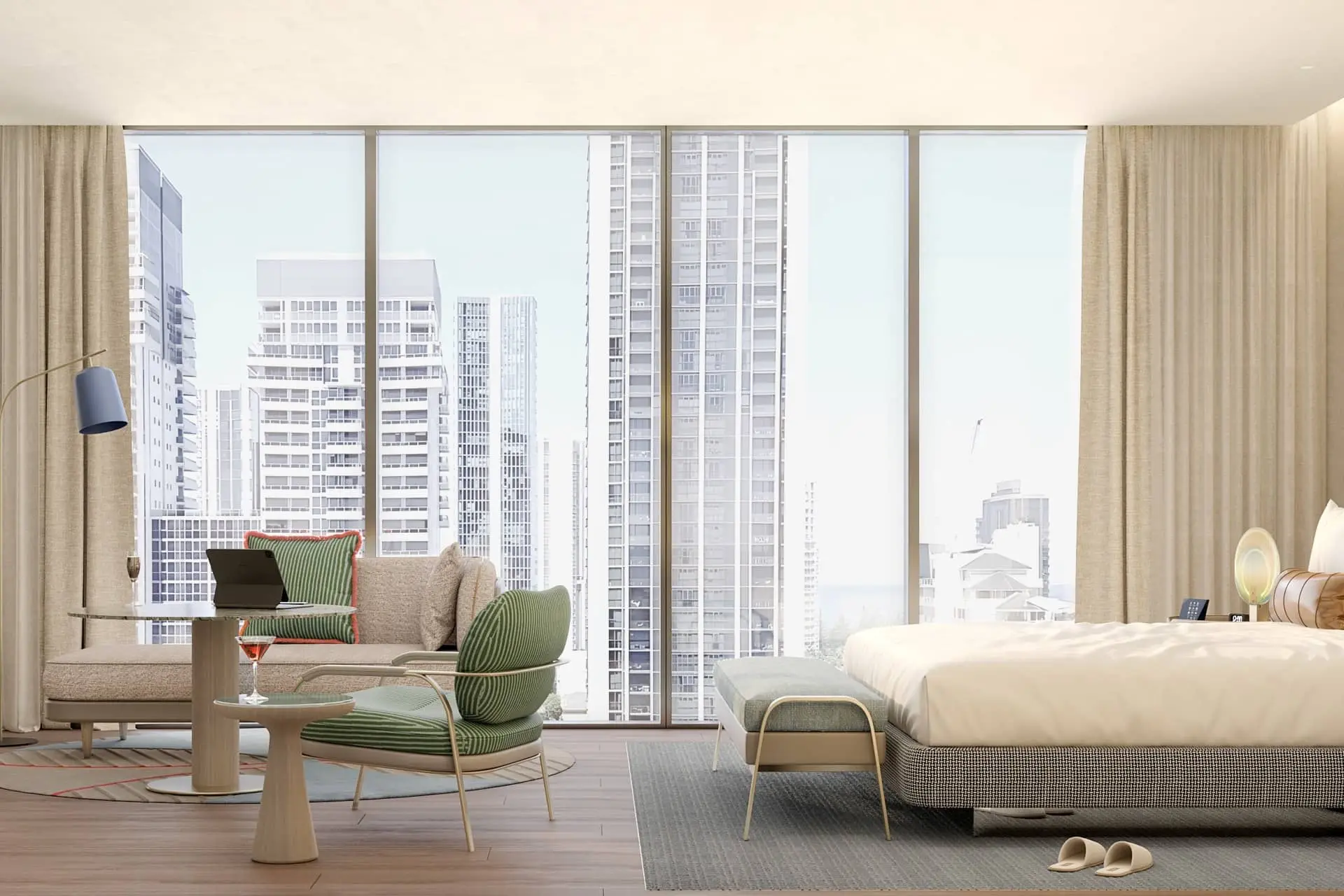Luxury hotel room with panoramic city views, modern seating, and a neatly made king bed