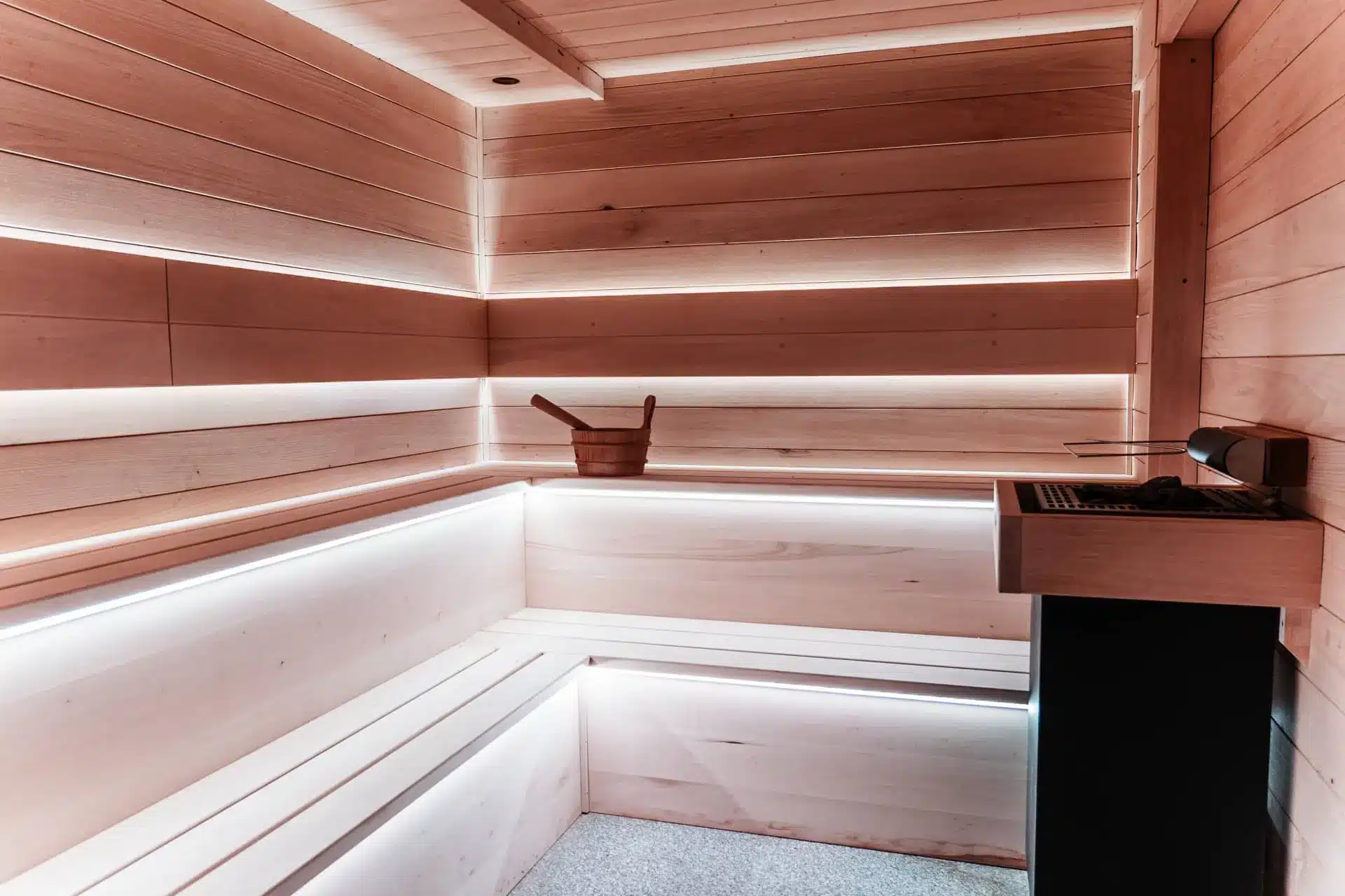 Modern wooden sauna interior with built-in benches and soft light glow