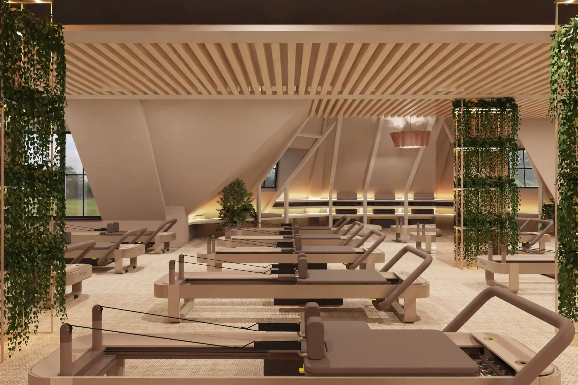 Interior of Pennyhill Park’s Reformer Pilates studio with rows of machines, wood slats and hanging greenery