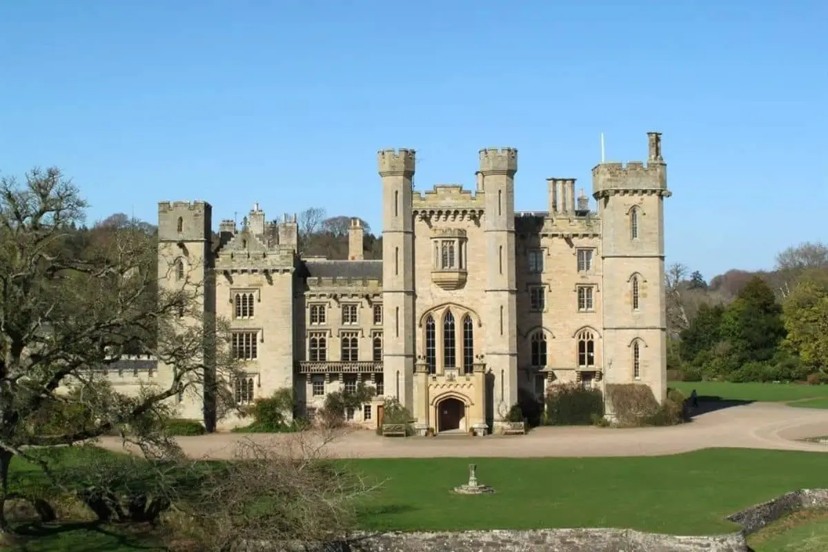 Duns Castle, a historic stone castle with towers and turrets, viewed across its green estate