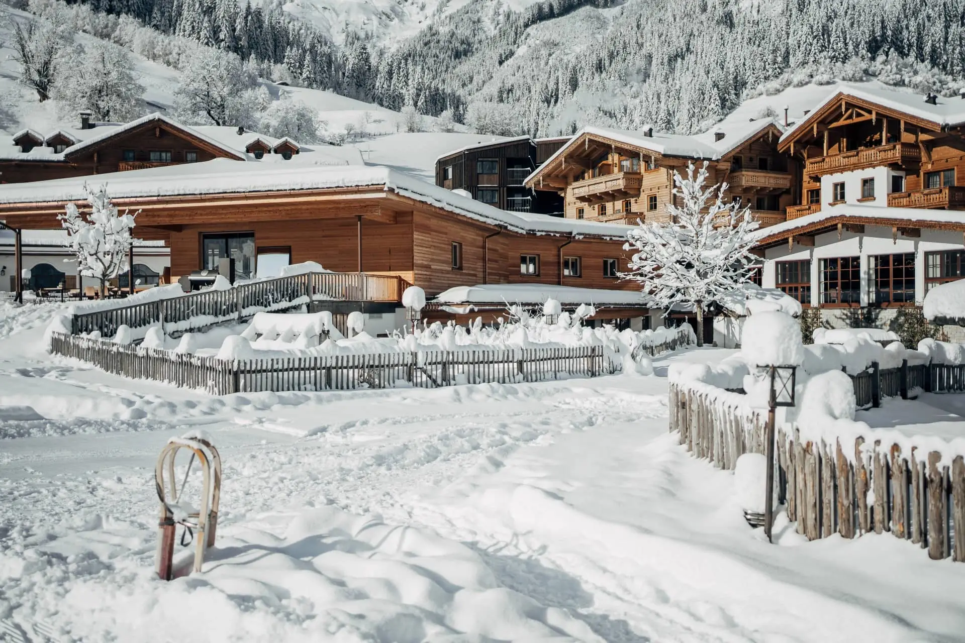 Snow-covered luxury chalets and mountain resort village in a winter Alpine landscape