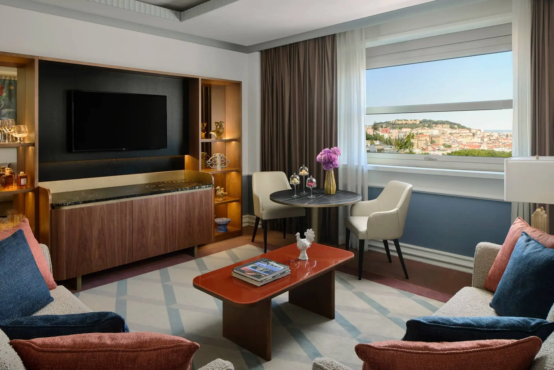 Elegant luxury hotel sitting room with panoramic coastal city views through a large window