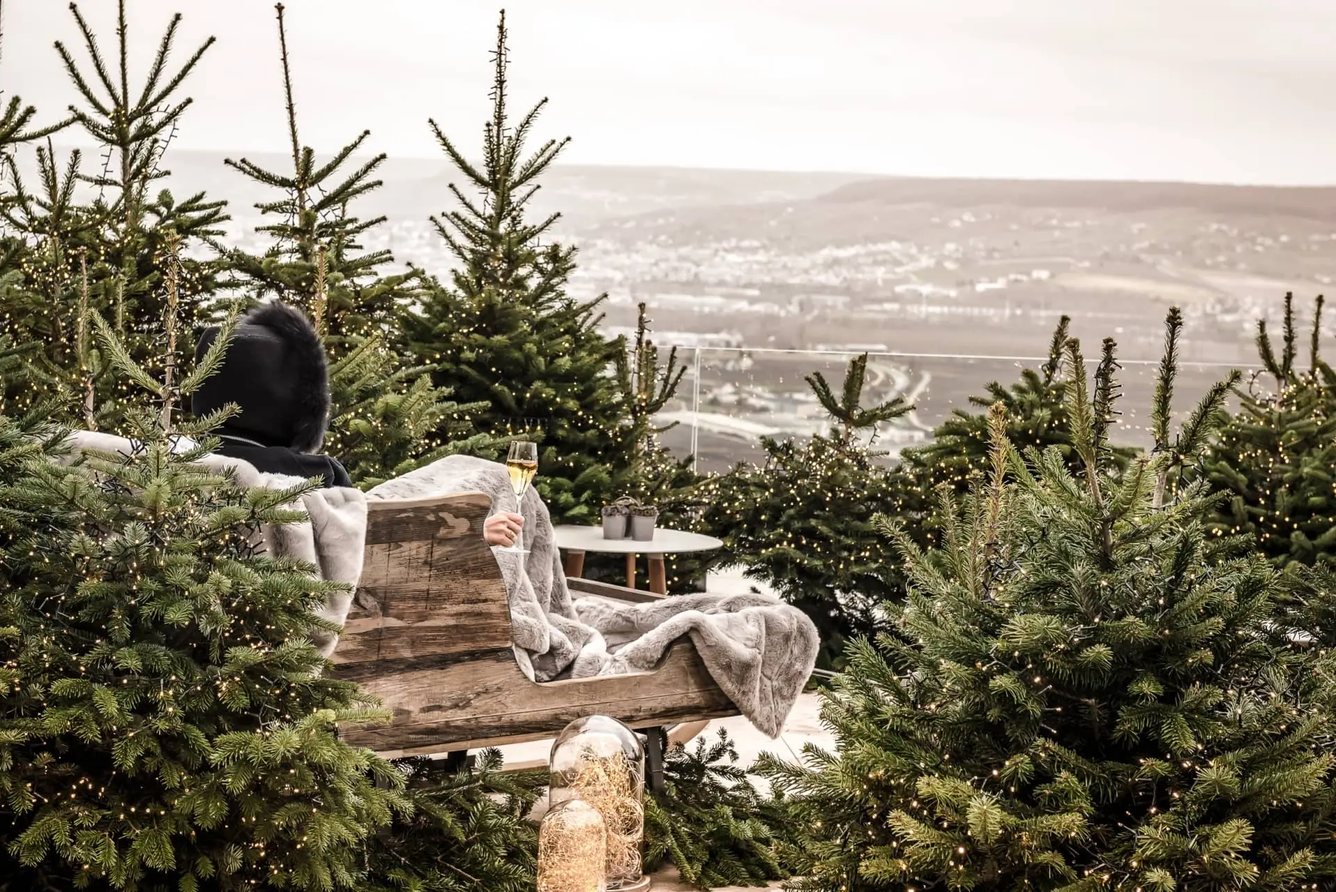 A guest relaxes on a terrace overlooking the vineyards at Royal Champagne Hotel & Spa.