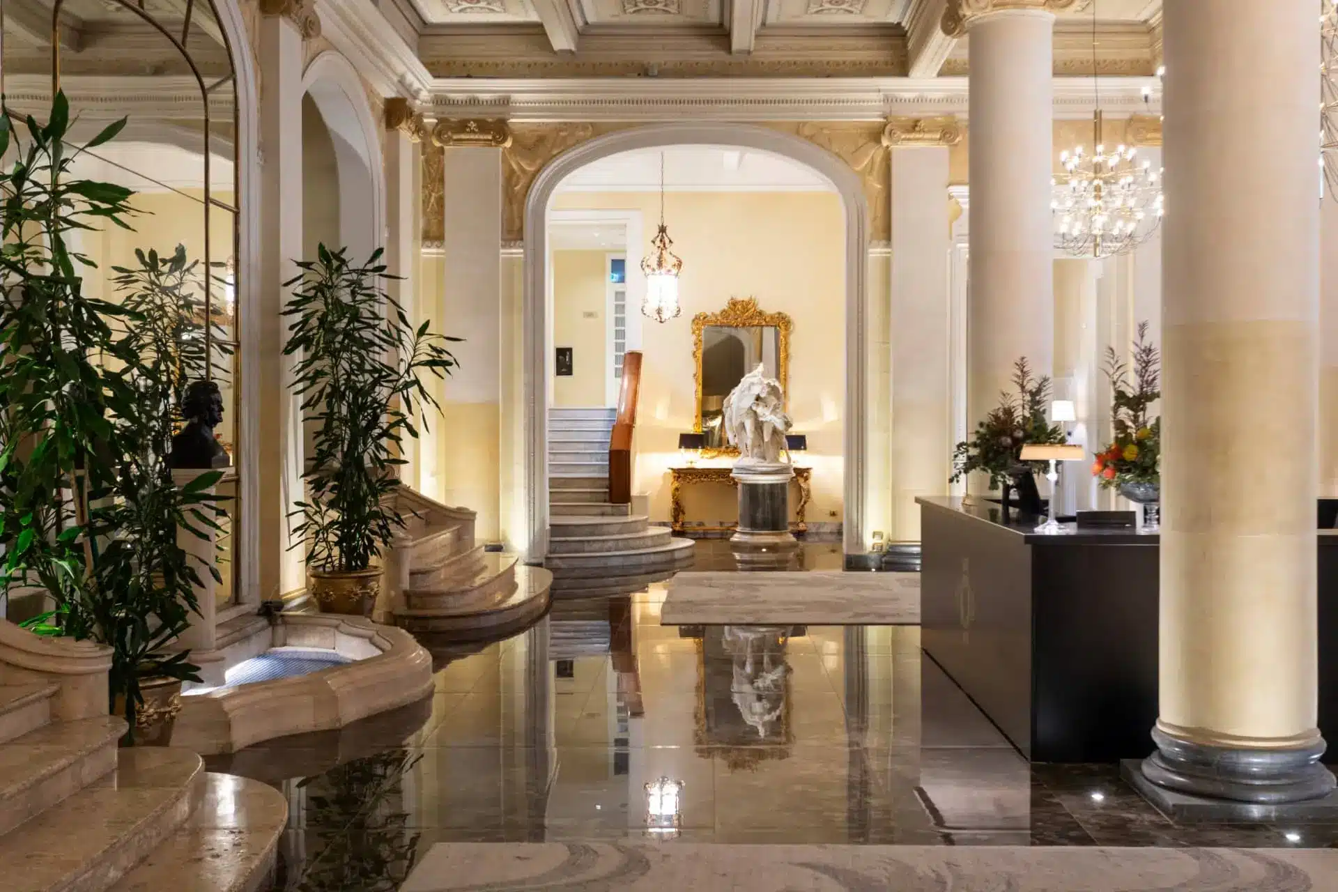 The hotel’s Winter Garden, with palms, columns and a reflective floor.