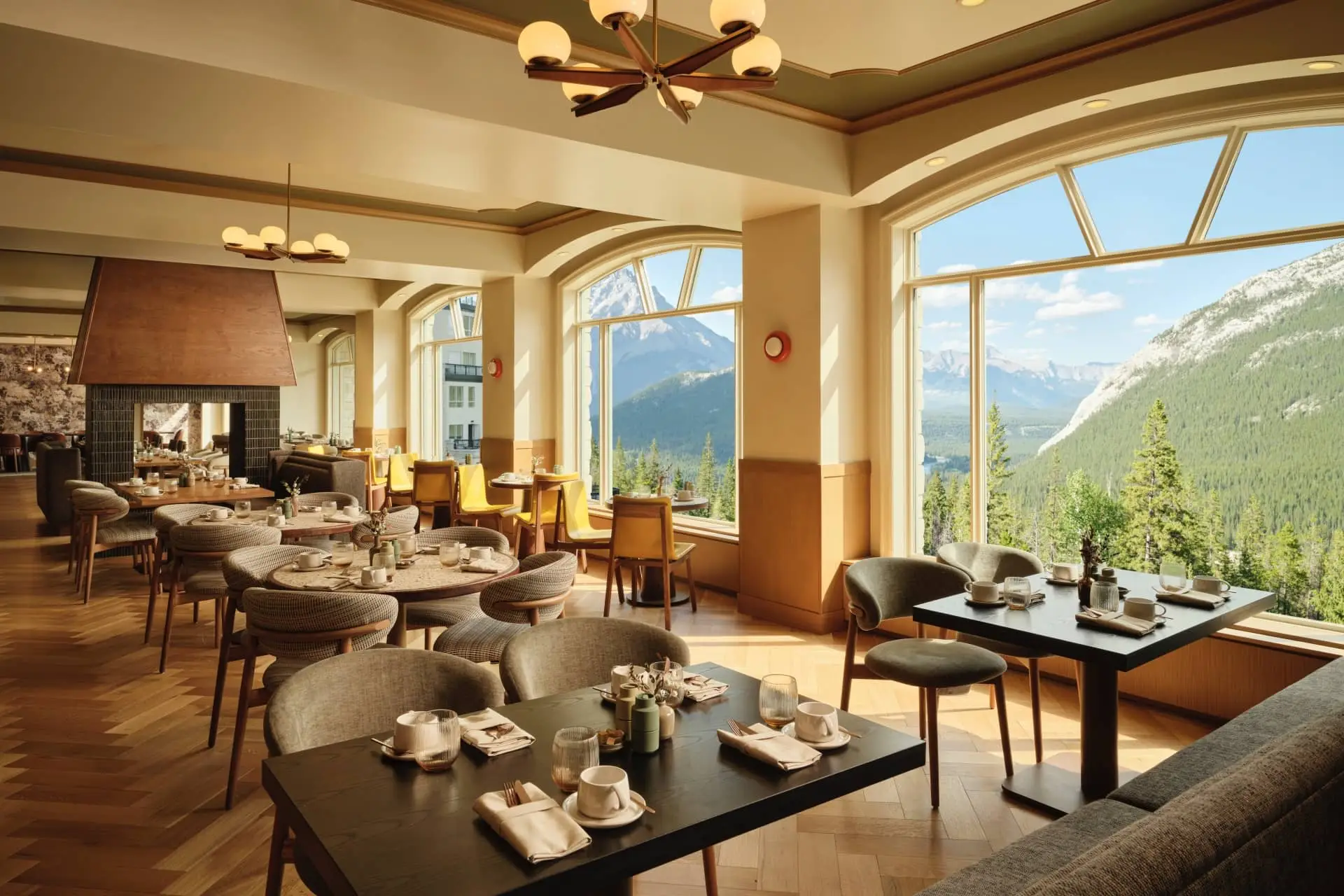 Elegant restaurant dining room with set tables and panoramic mountain views