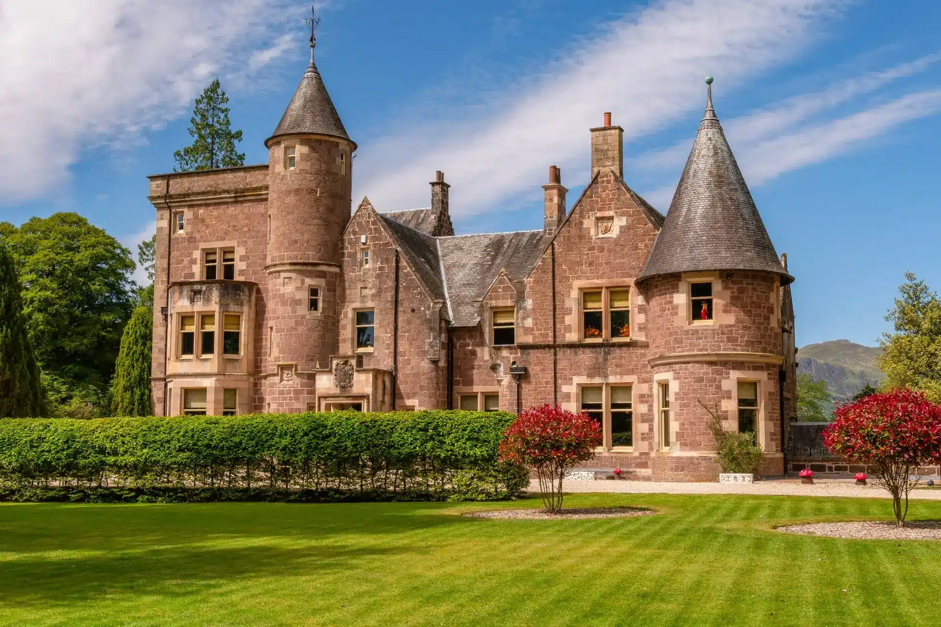 The Storied Garth, a turreted stone mansion set behind manicured lawns.